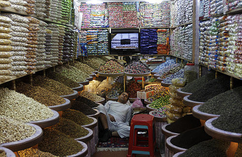 A man sleeps at his shop in Kabul.