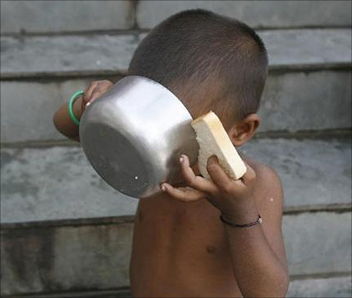 child has his breakfast at a flood relief camp in Purniya district town of Bihar.