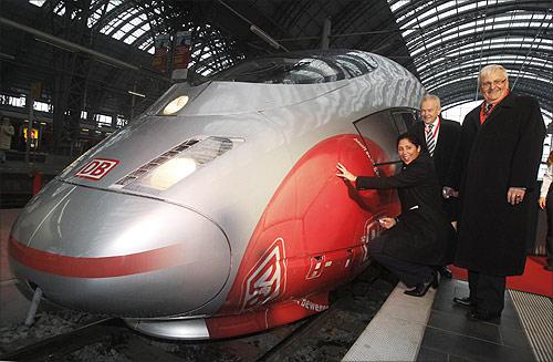 Rail operator Deutsche Bahn CEO Ruediger Grube (C) poses with Steffi Jones (L), head of the organization committee of the Women's Soccer World Cup and Theo Zwanziger (R) president of the German Football Association (DFB) in front of a ICE high speed train with the design of the Women's Soccer World Cup 2011, in Frankfurt.