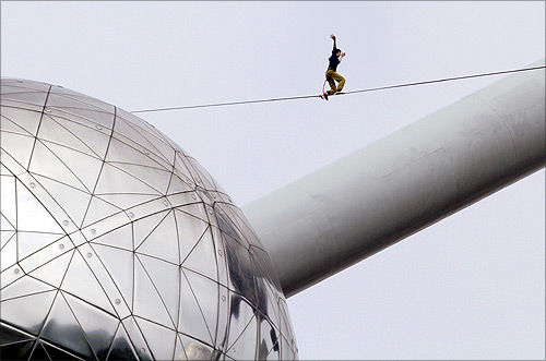 -A tightrope walker practises between two spheres of the Atomium monument in Brussels.