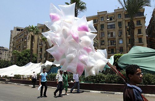 A street vendor sells candy during a sit-in against the military at Tahrir Square in Cairo.