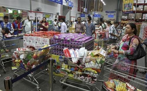 Customers wait to pay for their goods at a wholesale store.