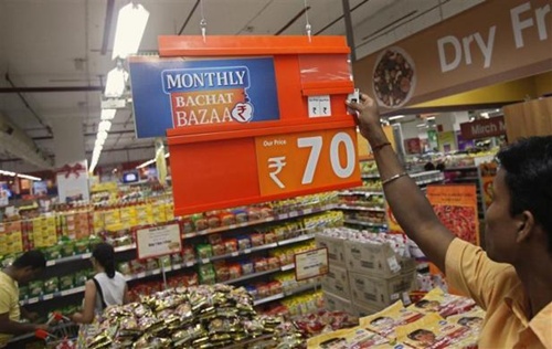 An employee changes the price tag of a product at the Big Bazaar retail store in Mumbai.