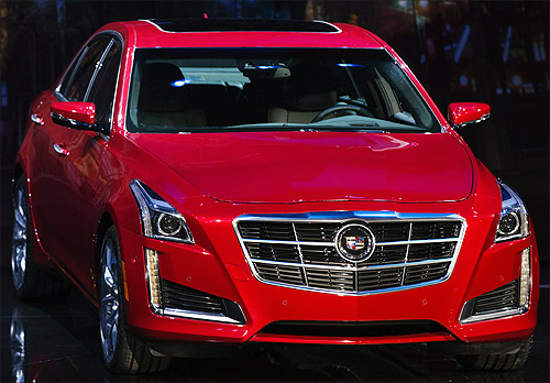 A 2014 Cadillac CTS sedan is displayed on stage during an unveiling ceremony in New York.