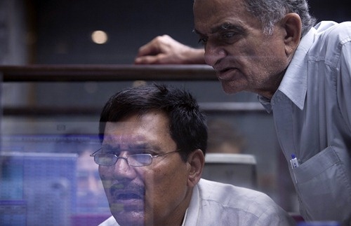 Brokers react as they monitor stock prices at the Karachi Stock Exchange.