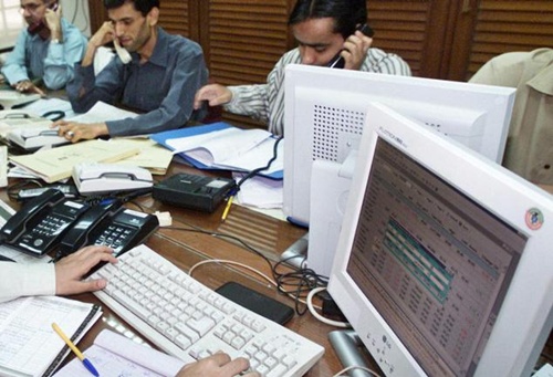 Traders monitor their stocks on computer monitors at the Karachi Stock Exchange.