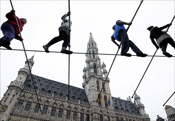Tightrope walkers perform on Brussels Grand Place.