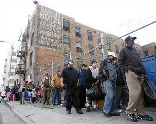 People line up for an early Thanksgiving meal served to the homeless at the Los Angeles Mission in downtown Los Angeles.