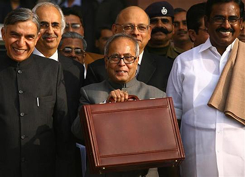 Pranab Mukherjee smiles as he leaves his office to present the 2009/10 interim budget in New Delhi.