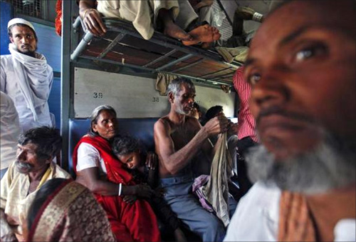 Passengers travel inside an overcrowded general class compartment of the Kalka Mail train in Kanpur.