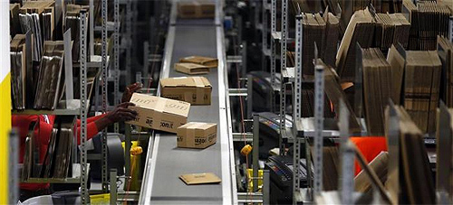 A worker packs boxes at Amazon's logistics centre in Graben near Augsburg.