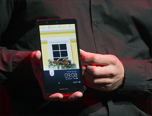 A model holds a Sharp IGZO Tablet Aquos Pad at their news conference during the Consumer Electronics Show (CES).