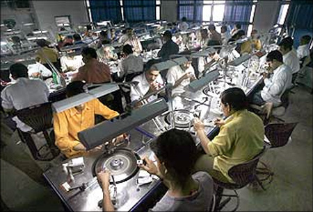 Employees work at a diamond cutting and polishing factory in Surat.