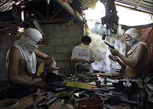 Filipino gunsmiths work in an illegal makeshift gun factory on the outskirts of Danao in central Philippines.
