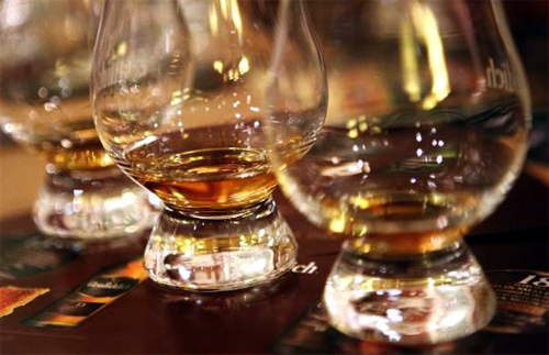 Glasses of scotch whisky sit on a table during a tour of the Glenfiddich scotch whisky distillery in Dufftown, Scotland.