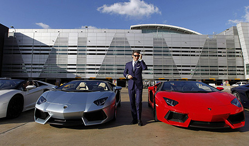 Stephan Winkelmann, President and CEO of Lamborghini, speaks to the media next to Aventador LP 700-4 Roadsters after a high-speed demonstration to mark the automaker's 50th Anniversary at Miami International Airport.
