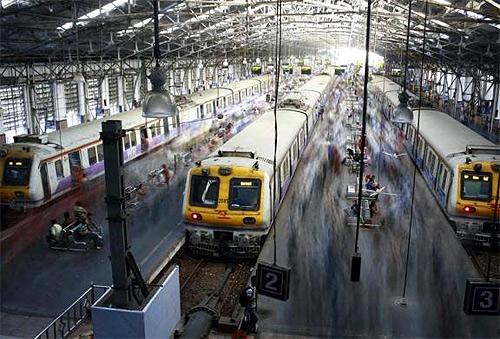 Commuters disembark from crowded suburban trains during the morning rush hour at Churchgate railway station in Mumbai.