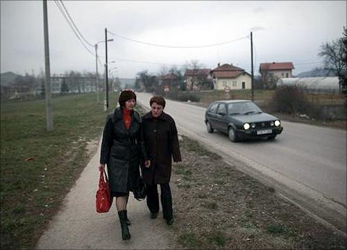 Sakiba Covic (R) and Semsa Hadzo head out to work at a coal mine in Breza.