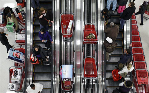 Shoppers ride an escalator at a Target Store in Chicago.
