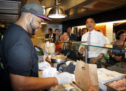 U.S. President Barack Obama orders a hamburger and fries at the Good Stuff Eatery on Capitol Hill in Washington.
