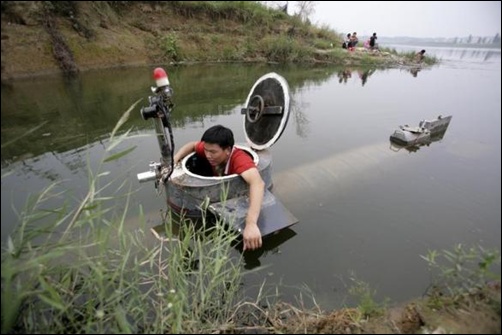 Tao Xiangli gets out of his homemade submarine after operating it in a lake on the outskirts of Beijing.