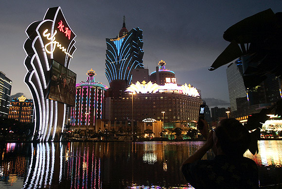 A man takes pictures of hotels and casinos with his mobile phone in Macau.