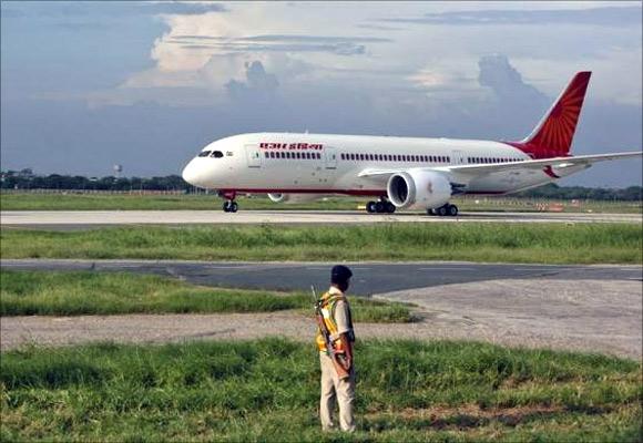 A security personnel stands guard as Air India's Dreamliner Boeing 787 taxies upon its arrival at the airport in New Delhi.