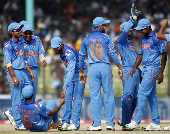 Indian players celebrate after picking up a wicket