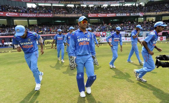 MS Dhoni leads the team into the ground