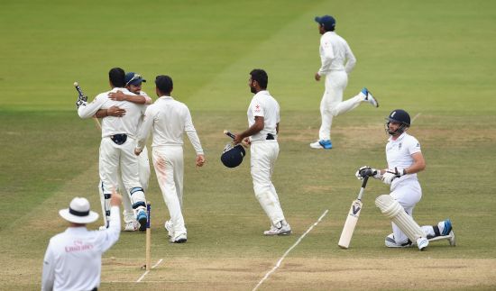 England batsman James Anderson lies stranded as umpire Bruce Oxenford raises the finger, and India players celebrate winning the Lord's Test