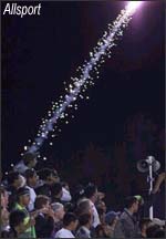 A flare is fired from the crowd