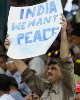 A Pakistani national holds up a poster