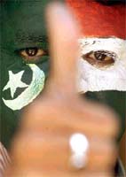 An Indian cricket fan with the national flags of India and Pakistan painted on his face