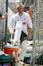 Australian leg-spinner Shane Warne puts on his pads during his first practice session in Colombo, Sri Lanka on February 29, 2004.