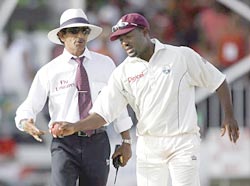 West Indies captain Brian Lara pulls the ball away from umpire Asad Rauf's hand.