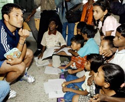 Sachin Tendulkar listens to children during a visit to Parikrama in Bangalore in September 2003