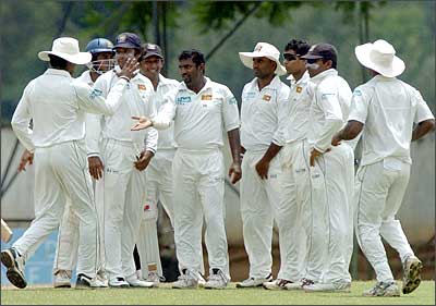 Murali is congratulated by teammates