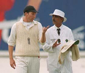 Umpire Ramaswamy with Michael Atherton