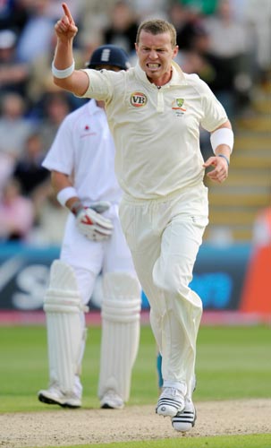 Australia's Peter Siddle celebrates the wicket of England's Andrew Flintoff for 37 during their first Ashes Test at Cardiff