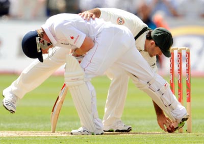 England's Paul Collingwood stops the ball hitting the stumps with his boot as Australia's Ricky Ponting picks it up during their first Ashes Test in Cardiff
