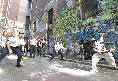 Indian students and the police play cricket on the street