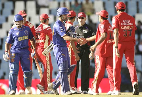 The Rajasthan Royals (in blue) and the Bangalore Royal Challengers shake hands at the end of the match