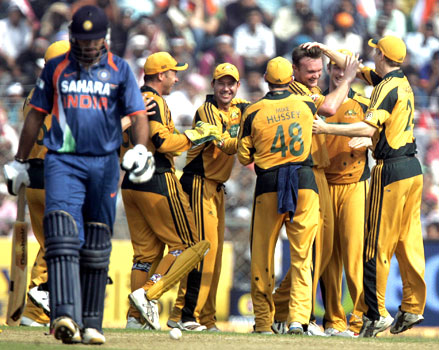The Australian team celebrates the dismissal of Yuvraj Singh
