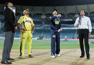 Adam Gilchrist of the Chargers tosses the coin with MS Dhoni of the Super Kings looking on ahead of the 2010 DLF Indian Premier League T20 semi final match