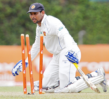 Sri Lanka's Tillakaratne Dilshan watches as he is run out