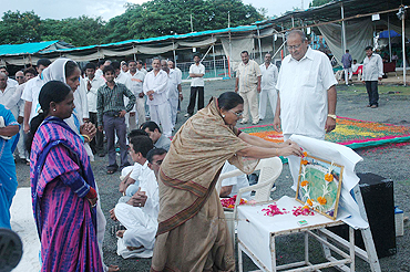 A lady offers flowers during the 'condolence meeting' at Madhavrao Scindia Cricket Ground