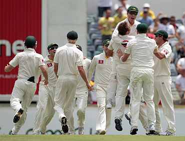 Australian players celebrate after winning the thrid Ashes Test against England in Perth