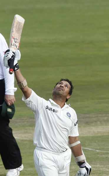 Sachin Tendulkar raises his bat after completing his 50th Test ton