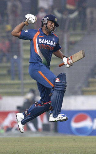 Suresh Raina reacts after completing his century