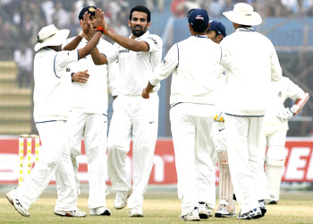 Indian fielders congratulate Zaheer Khan (3rd from left) after dismissing Bangladesh's Imrul Kayes